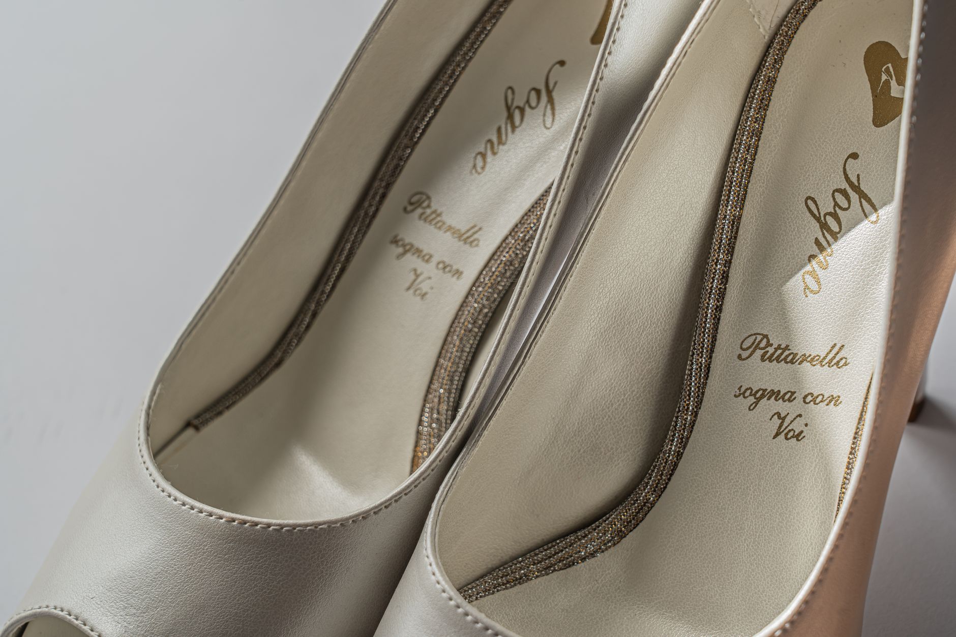 Detail shot of textured fabric shoes styled alongside tailored trousers