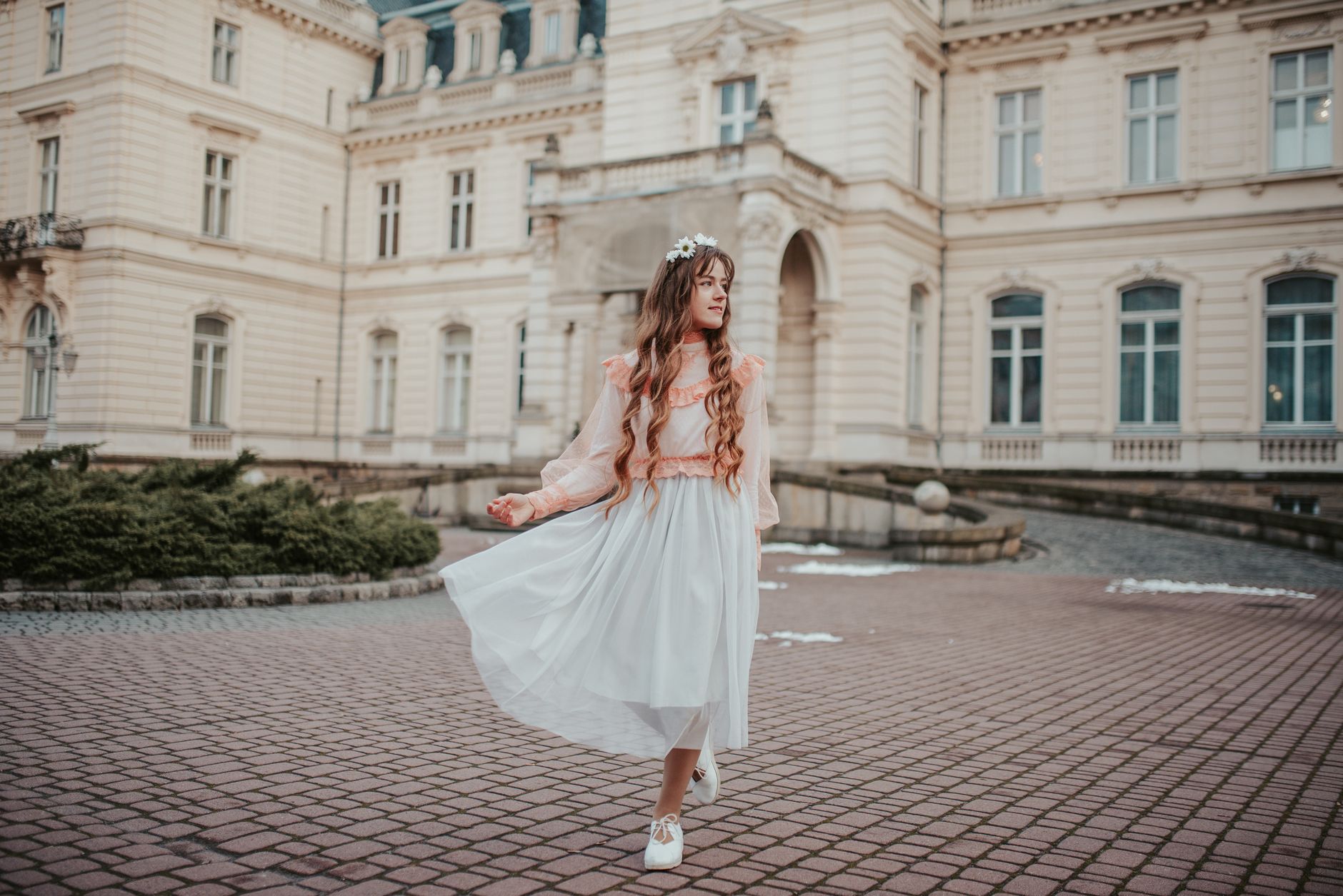 Woman wearing a soft feminine outfit styled with flat shoes