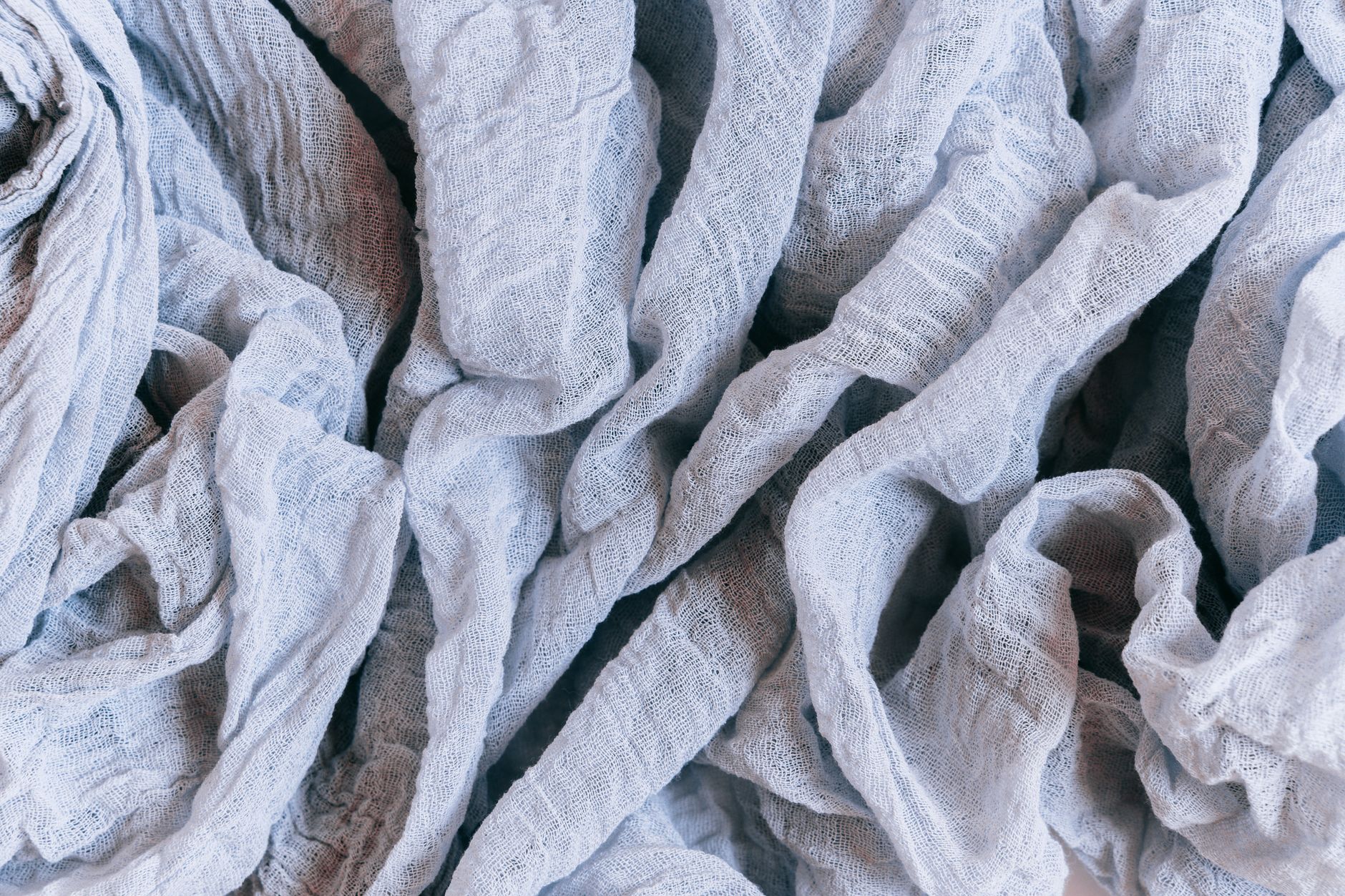 Close-up of natural linen fabric texture showing characteristic slub weave