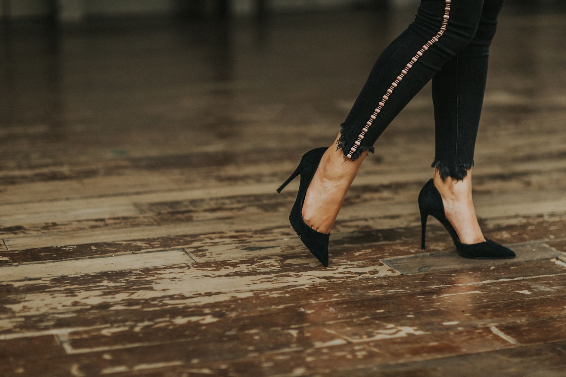 Woman wearing an architectural heel with tailored trousers
