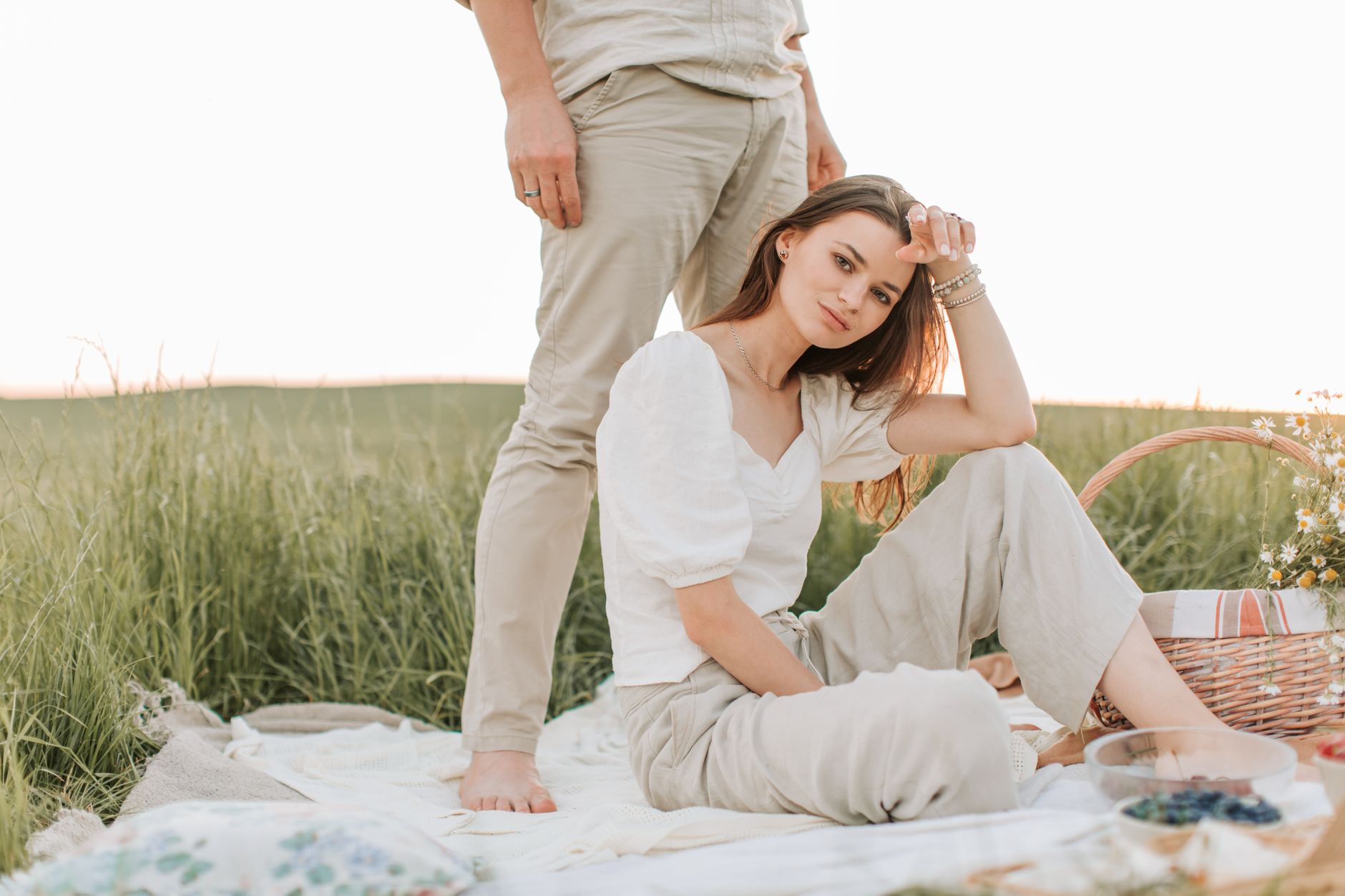 Linen trousers and summer wardrobe laid out on a white surface