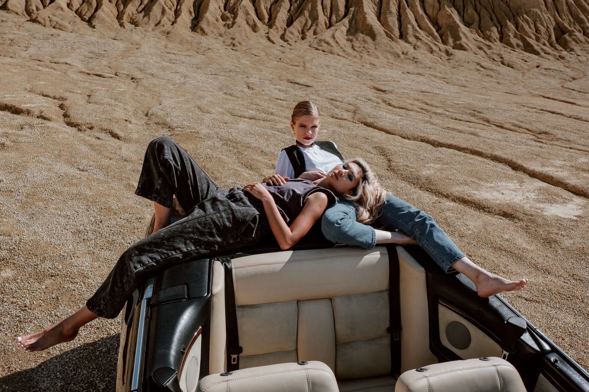 Model wearing relaxed earth-toned trousers in a bright natural setting