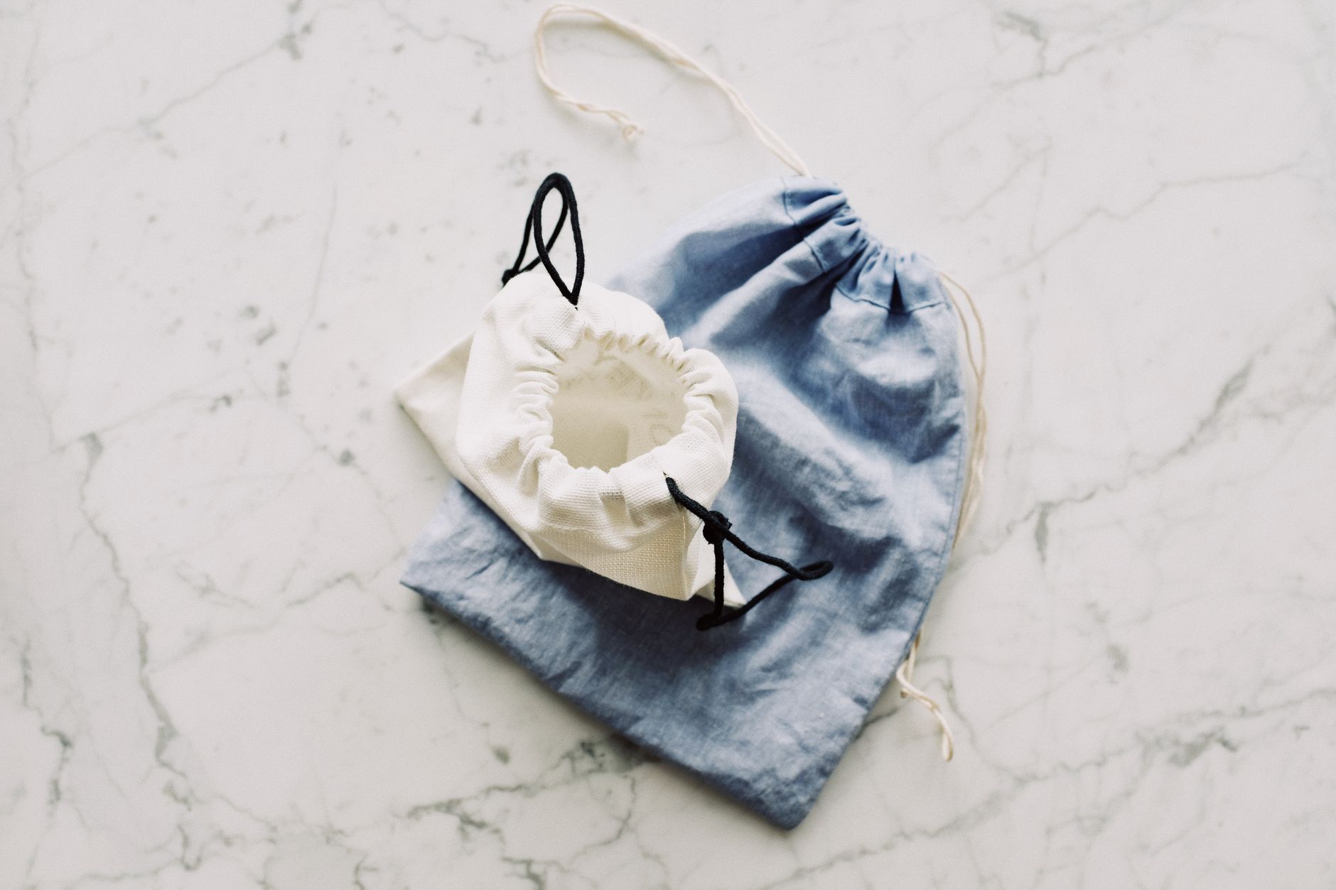 Natural fiber accessories including a tote bag styled with summer clothing