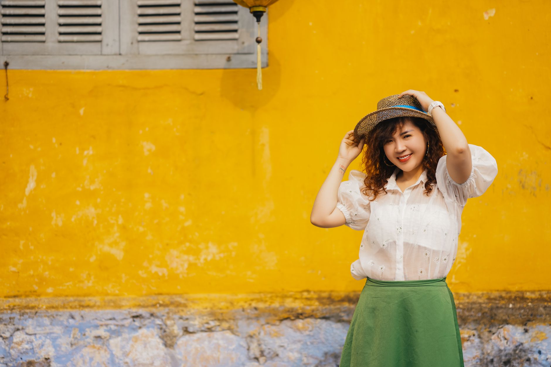 Casual summer outfit featuring a light embroidered blouse with jeans