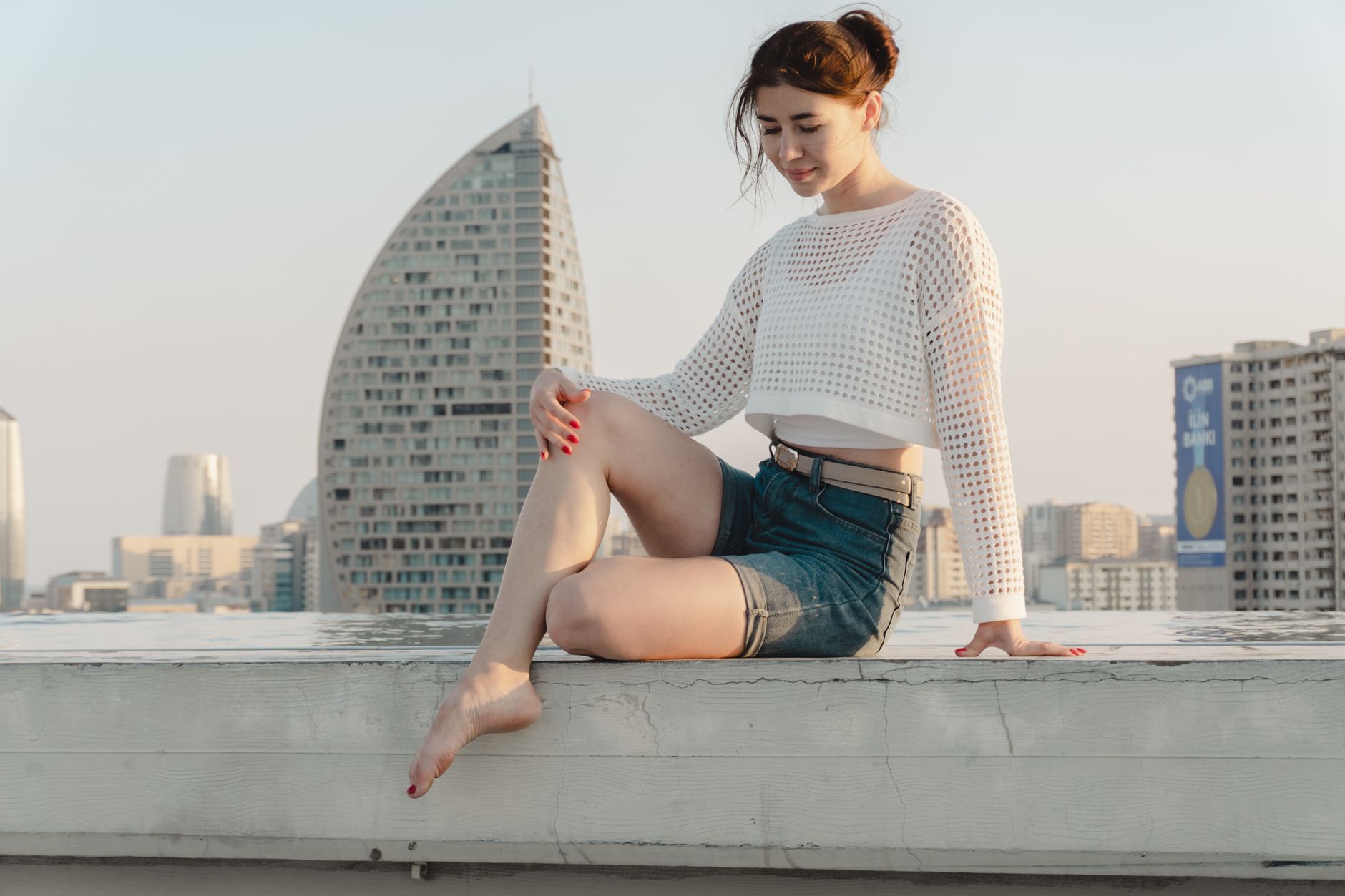 Woman wearing a light summer outfit with flat shoes, photographed from below the knee